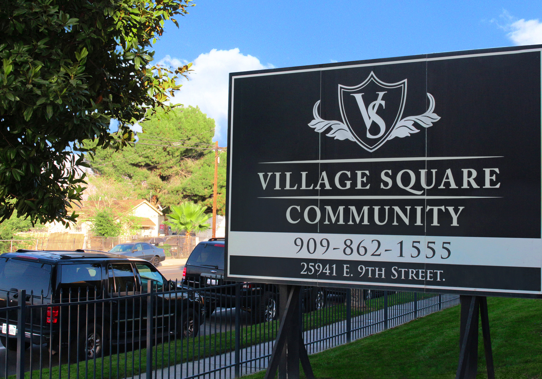 This image shows the entrance marker photo of Village Square Apartments