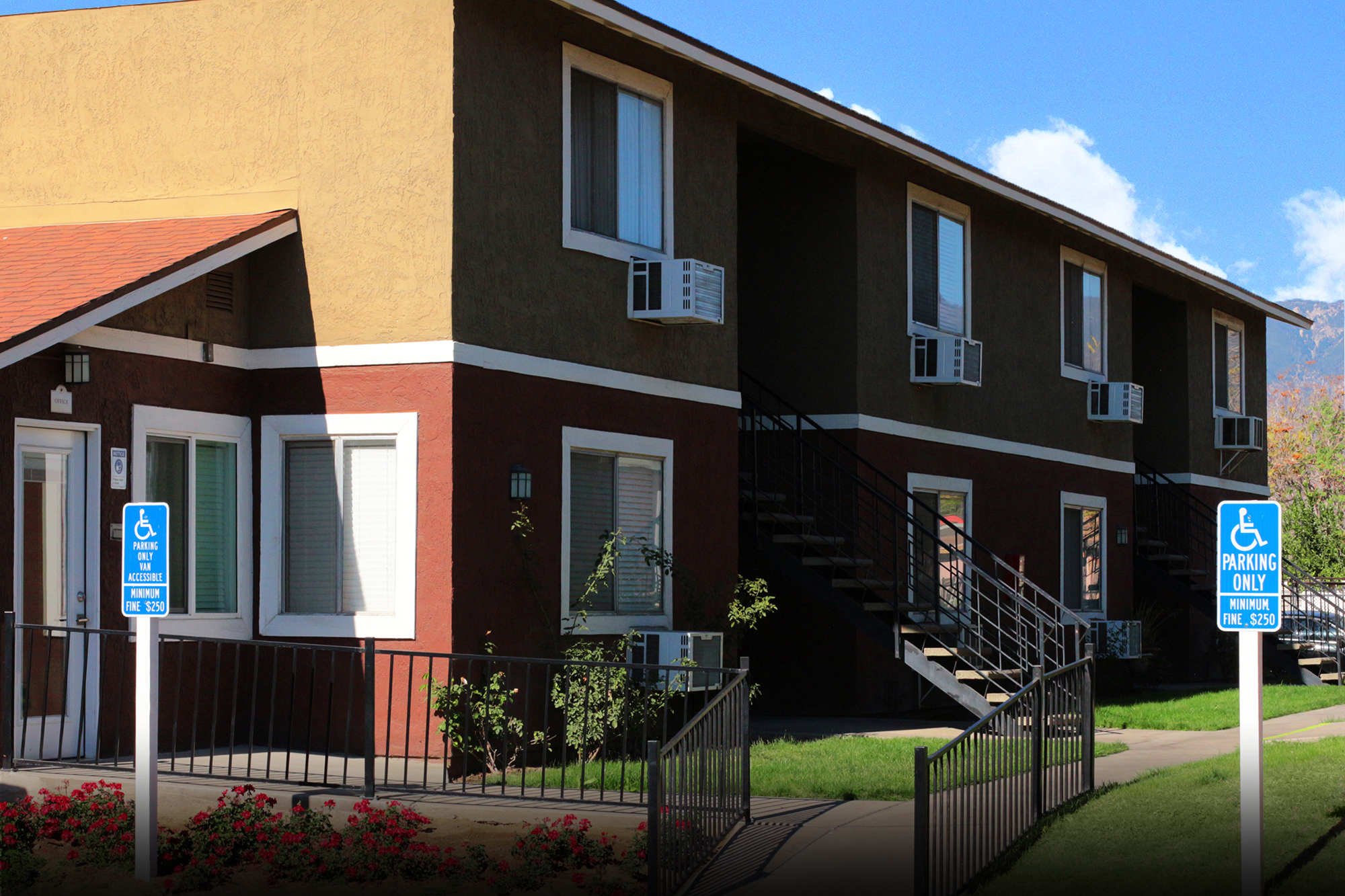 This banner image shows the exterior photo of Villa De La Rosa Apartments